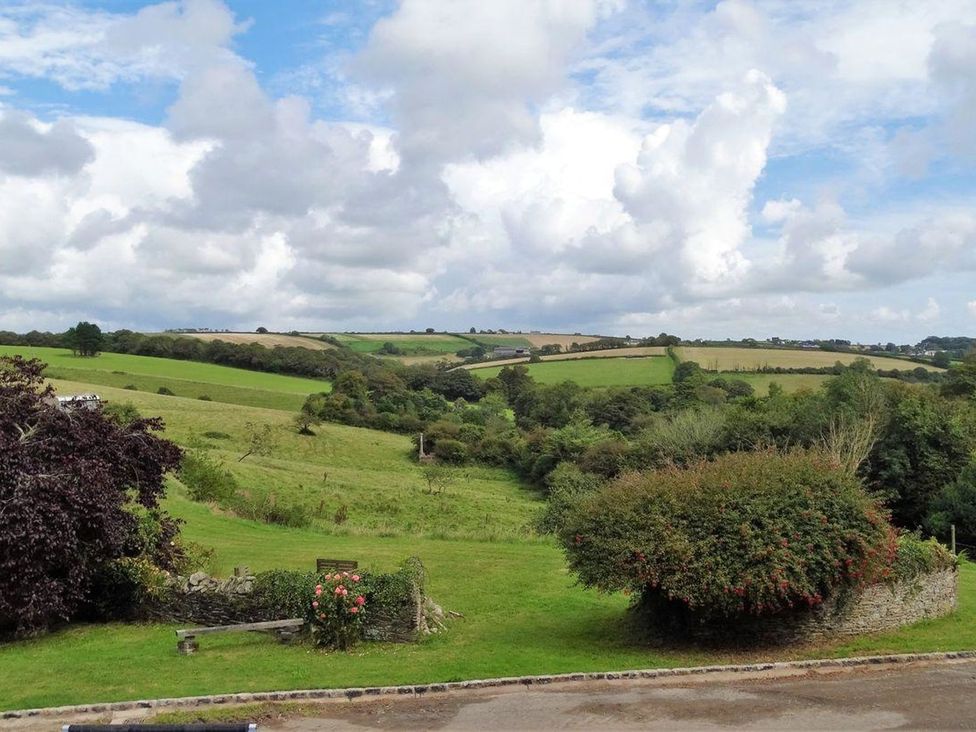 A landscape view with fields and trees at The Cider Barn at Home Farm Down Thomas near Wembury