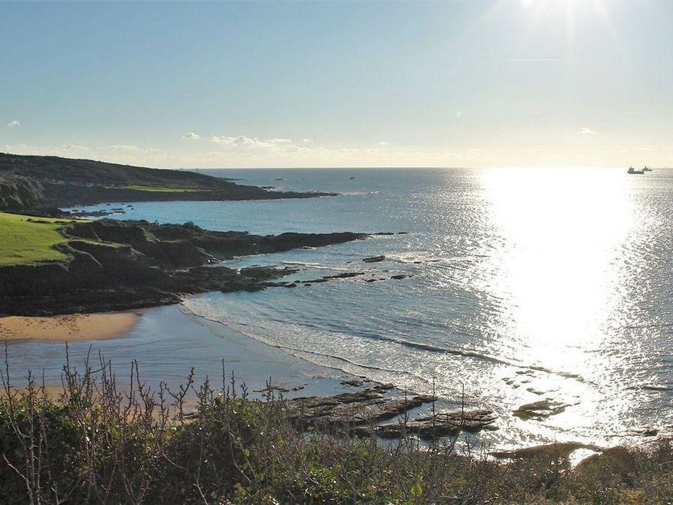 A coastal view with a beach and water at The Cider Barn at Home Farm Down Thomas near Wembury