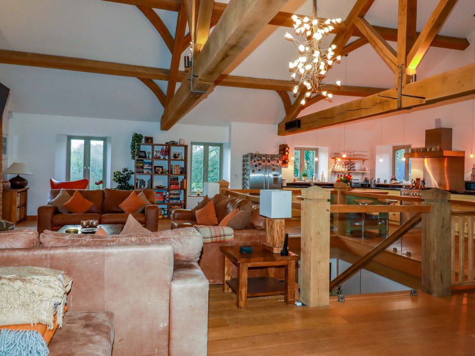 A living room with a sofa and bookshelf at Kerslake House in Crafthole