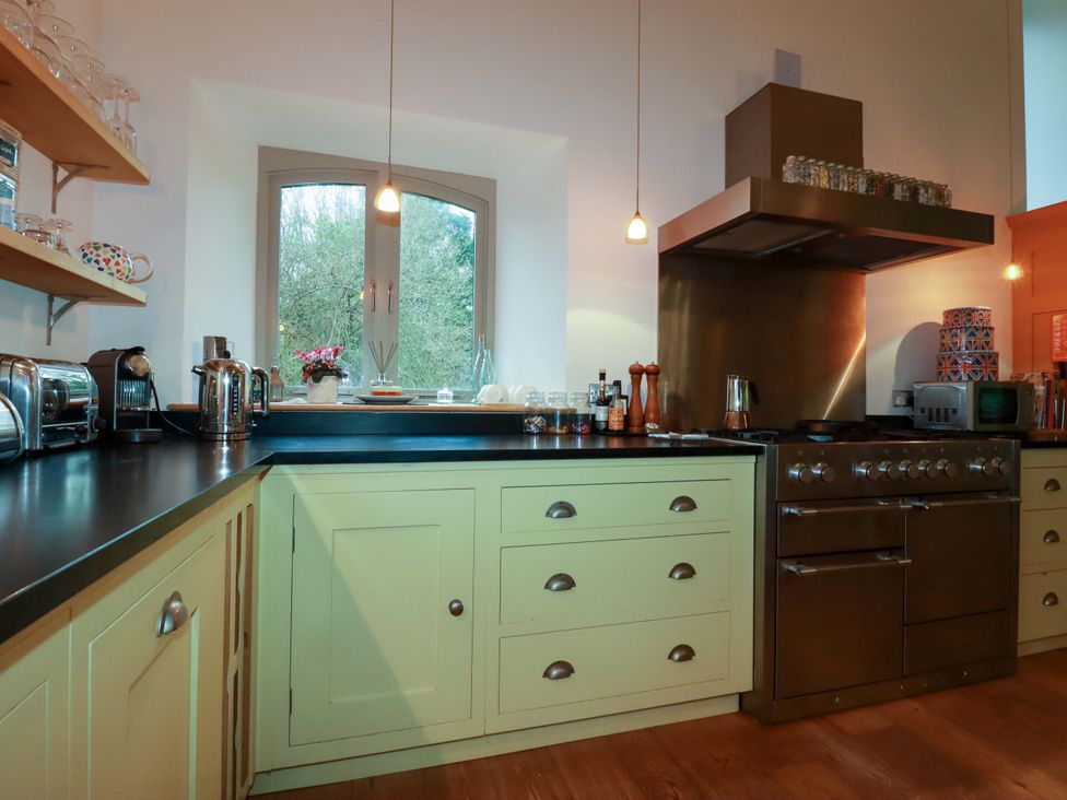 A kitchen with a window and stove at Kerslake House in Crafthole