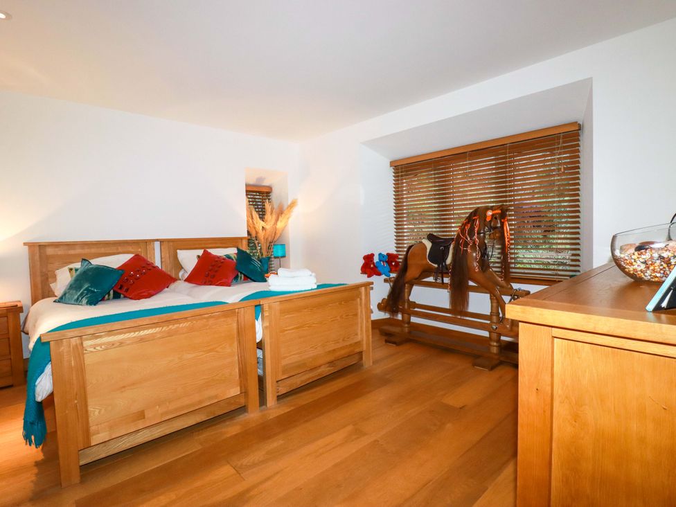 A bedroom with two beds and a rocking horse at Kerslake House in Crafthole