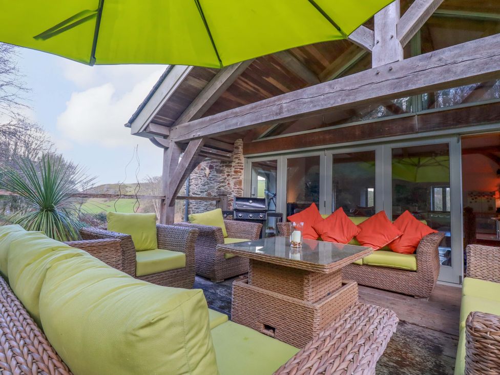 An outdoor seating area with a table and chairs at Kerslake House in Crafthole