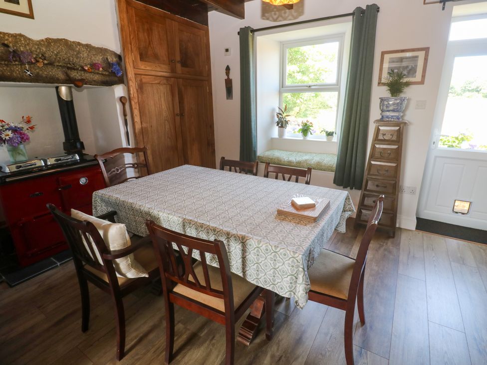 A dining room with a table and chairs at Halwyn Farm in Helston