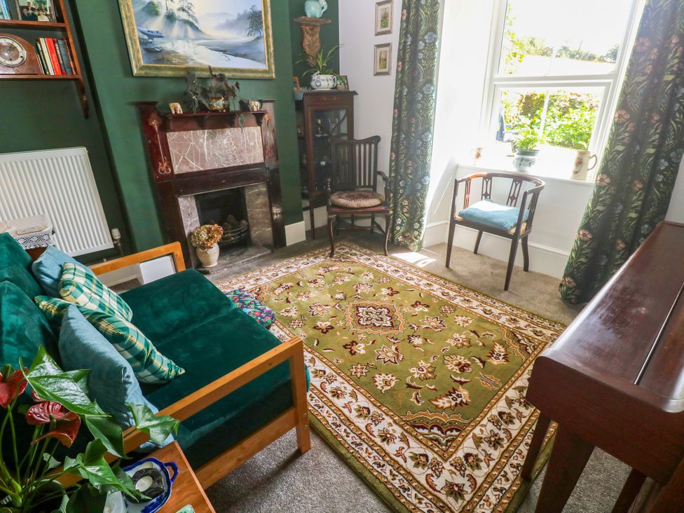 A living room with a rug and sofa at Halwyn Farm in Helston