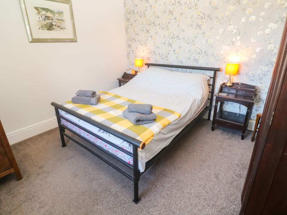 A bedroom with a bed and bedside tables at Halwyn Farm in Helston