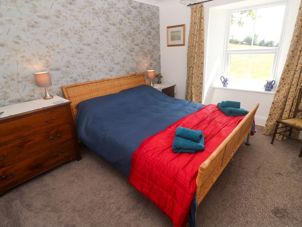 A bedroom with a bed and a chest of drawers at Halwyn Farm in Helston