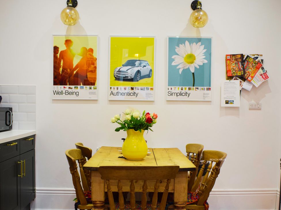 A kitchen with a table and chairs at 21 Gensing Road in St. Leonards-on-Sea