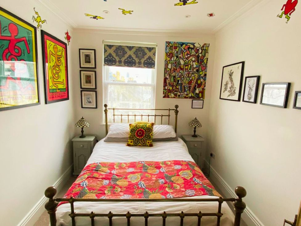 A bedroom with a bed and decorative wall art at 21 Gensing Road St. Leonards-on-Sea