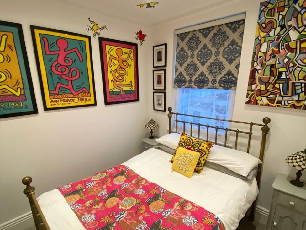 A bedroom with a bed and decorative wall art at 21 Gensing Road St. Leonards-on-Sea
