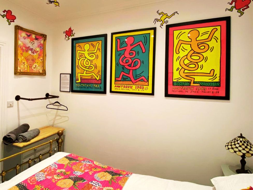 A bedroom with artwork on the walls and a bed at 21 Gensing Road St. Leonards-on-Sea