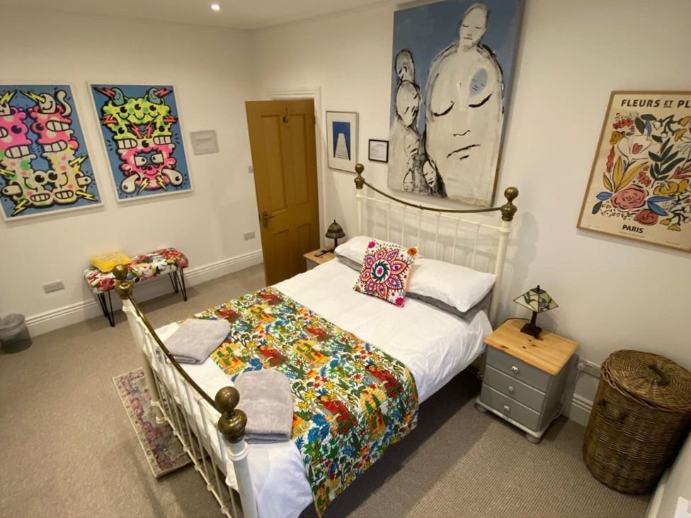 A bedroom with a bed and wall art at 21 Gensing Road St. Leonards-on-Sea