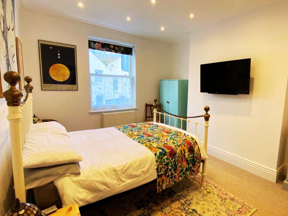 A bedroom with a bed and wardrobe at 21 Gensing Road in St. Leonards-on-Sea