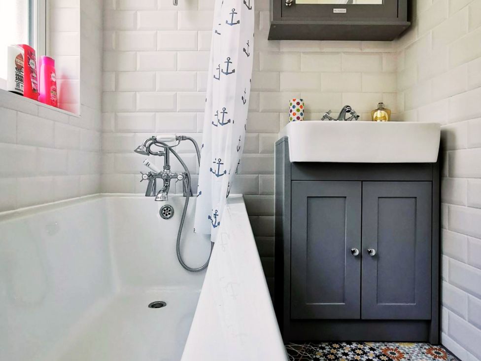 A bathroom with a bathtub and vanity sink at 21 Gensing Road St. Leonards-on-Sea