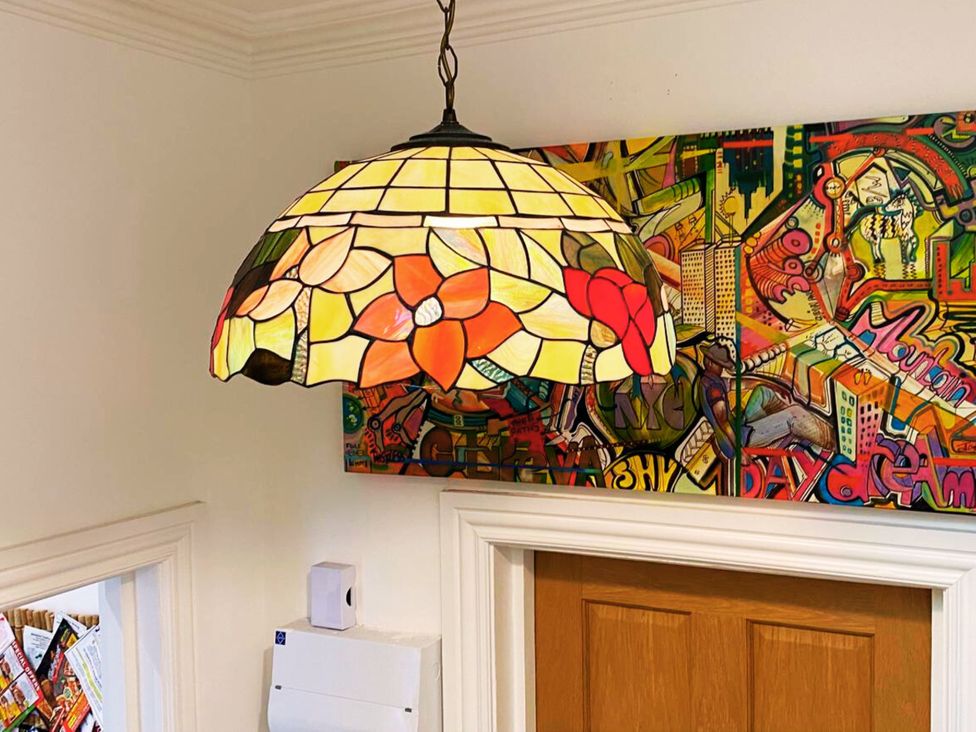 A lamp hanging above a colorful artwork at 21 Gensing Road, St. Leonards-on-Sea