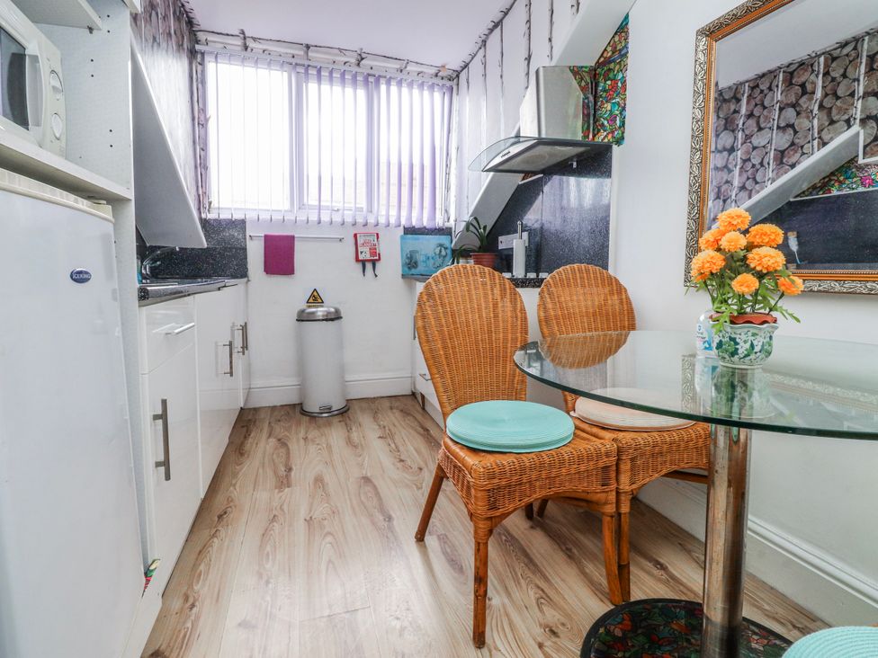 A kitchen with a dining table and chairs at Number 8 in Blackpool