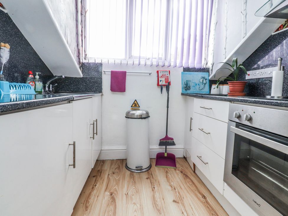 A kitchen with a sink and cabinets at Number 8 Blackpool