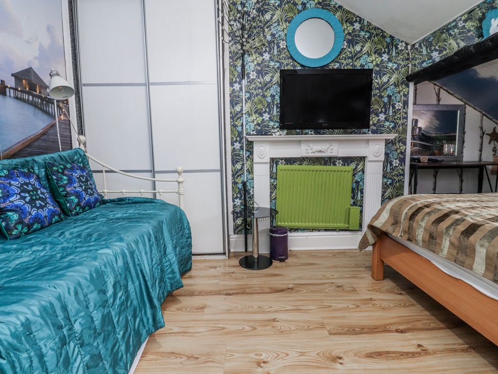 A bedroom with a bed and television at Number 8 in Blackpool