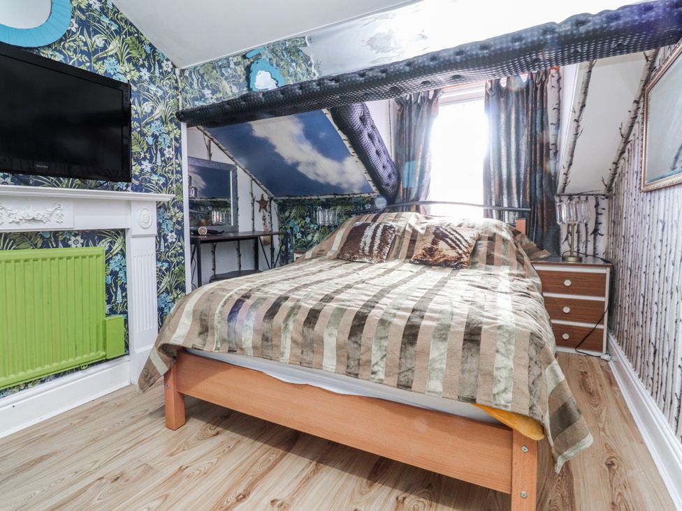 A bedroom with a bed and television at Number 8 in Blackpool