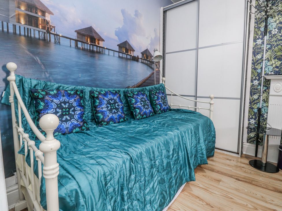 A bedroom with a day bed and cushions at Number 8 in Blackpool