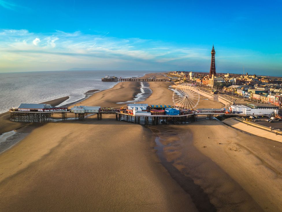 A pier with a ferris wheel and buildings at Number 8 in Blackpool