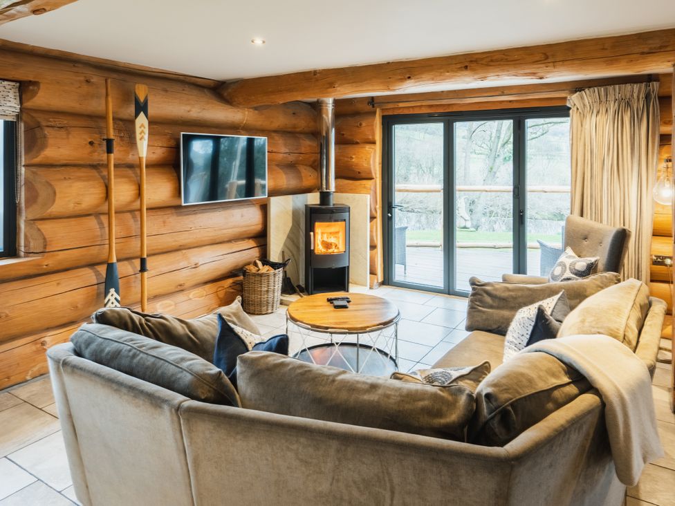 A living room with a sofa and a wood stove at The Lookout in Addingham