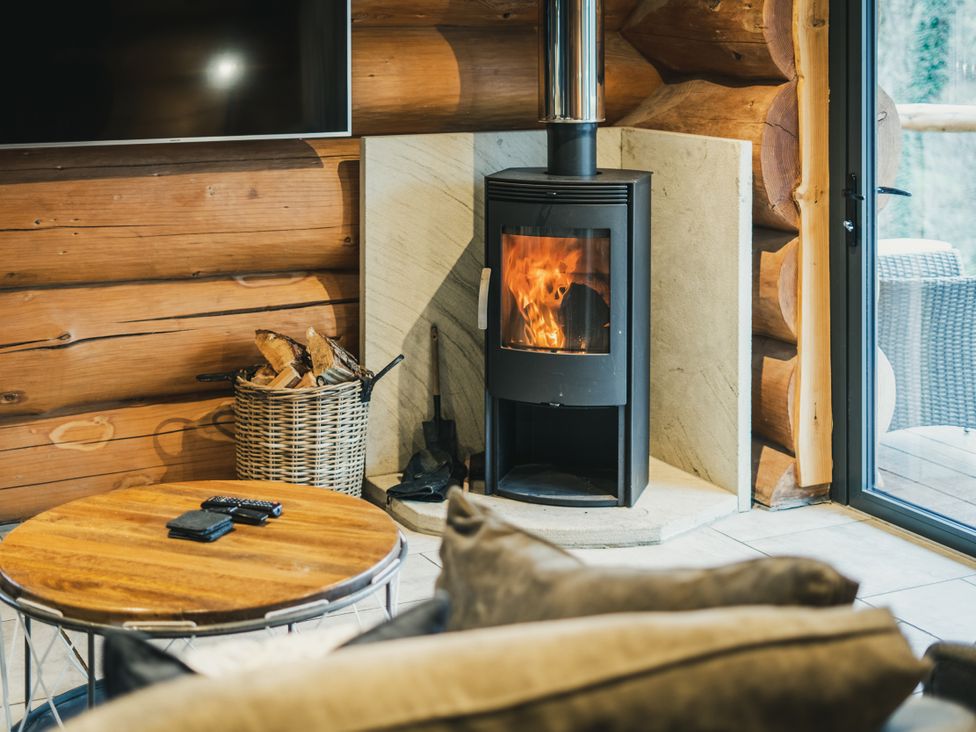 A living room with a stove and coffee table at The Lookout in Addingham