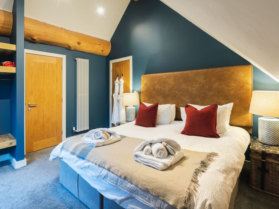 A bedroom with a double bed and bedside lamps at The Lookout in Addingham