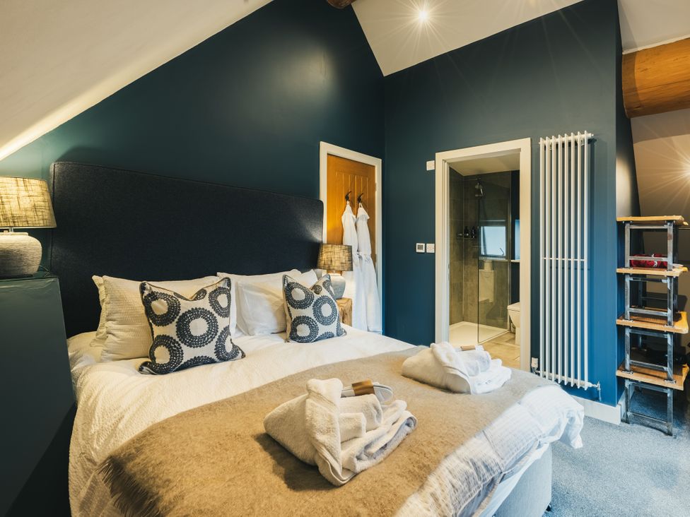 A bedroom with a bed and shower area at The Lookout in Addingham