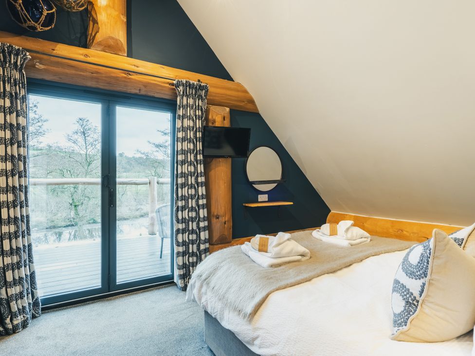 A bedroom with a bed and sliding door at The Lookout in Addingham