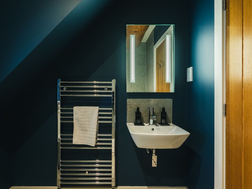 A bathroom with a towel radiator and sink at The Lookout in Addingham