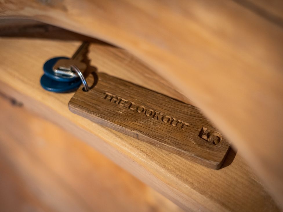 A key with a wooden tag labeled The Lookout