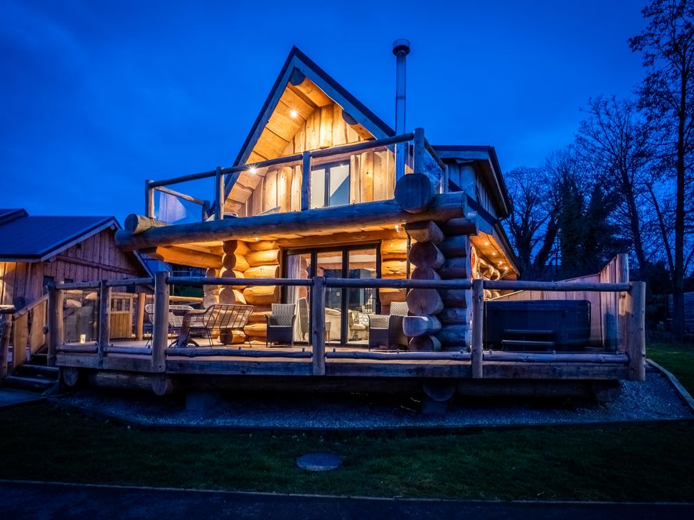 A log cabin with a deck and chairs at The Lookout in Addingham