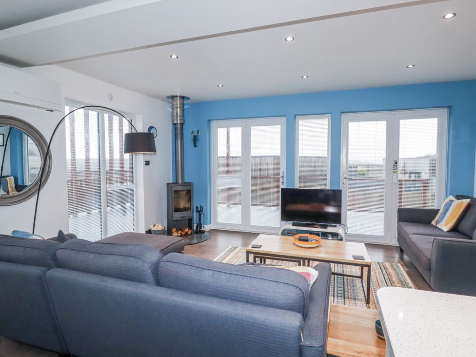 A living room with a sofa and TV at Pentewan in Redruth