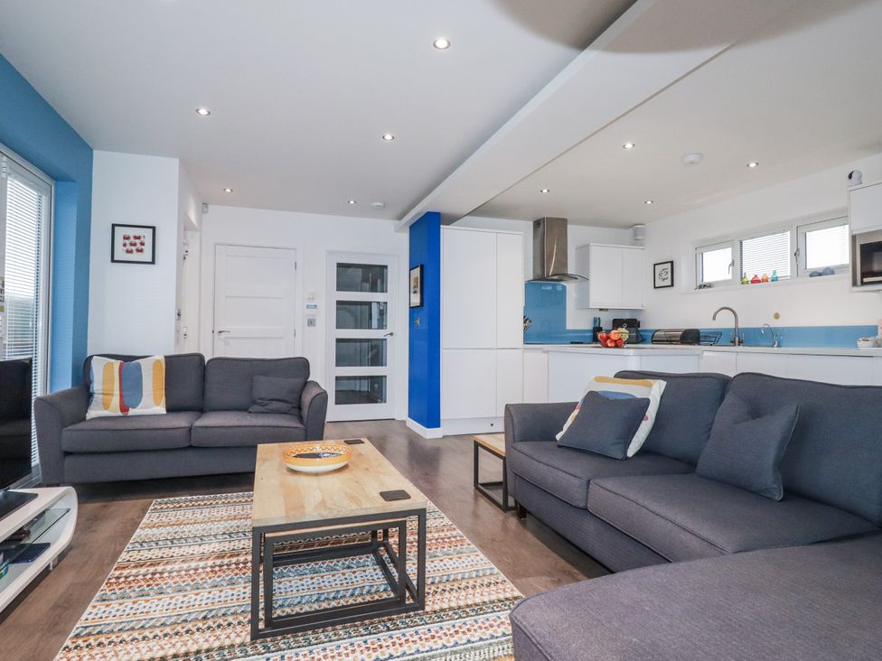 A living room with a sofa and coffee table at Pentewan Redruth