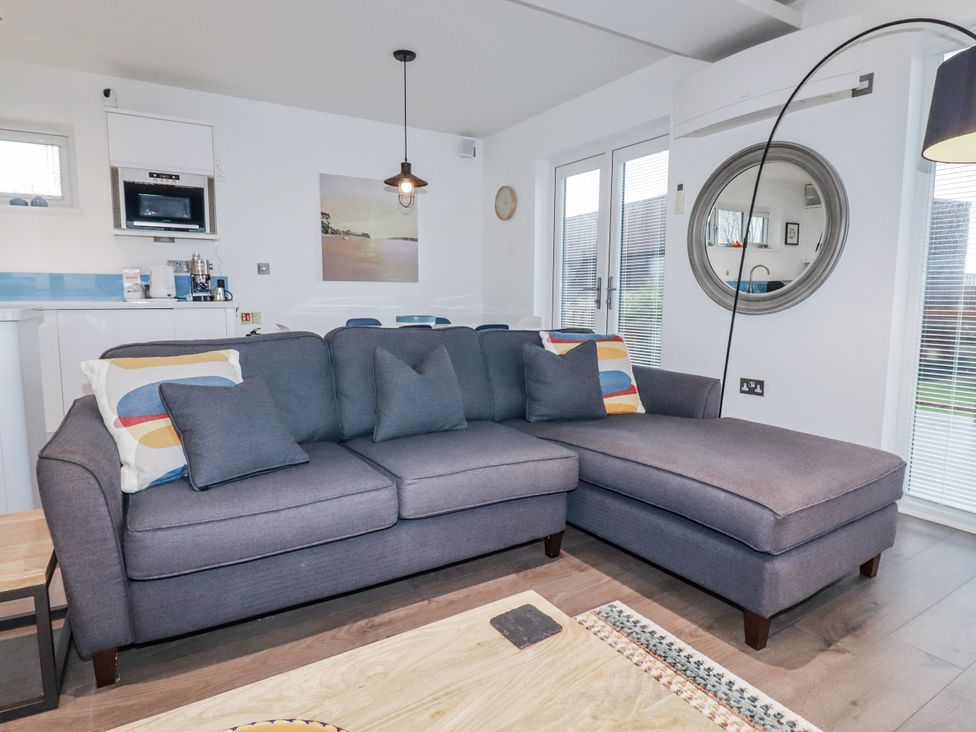 A living room with a sofa and coffee table at Pentewan in Redruth