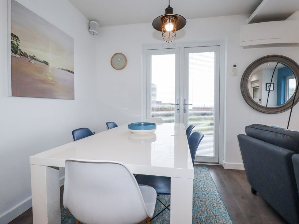 A dining room with a table and chairs at Pentewan in Redruth