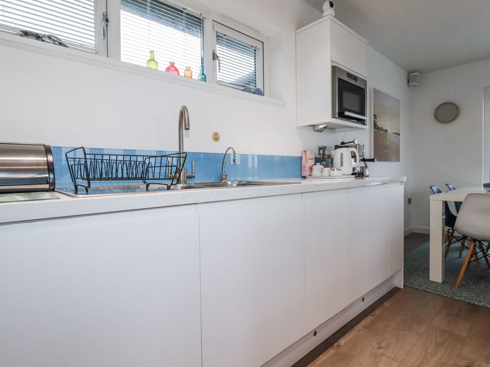 A kitchen with sink and appliances at Pentewan in Redruth