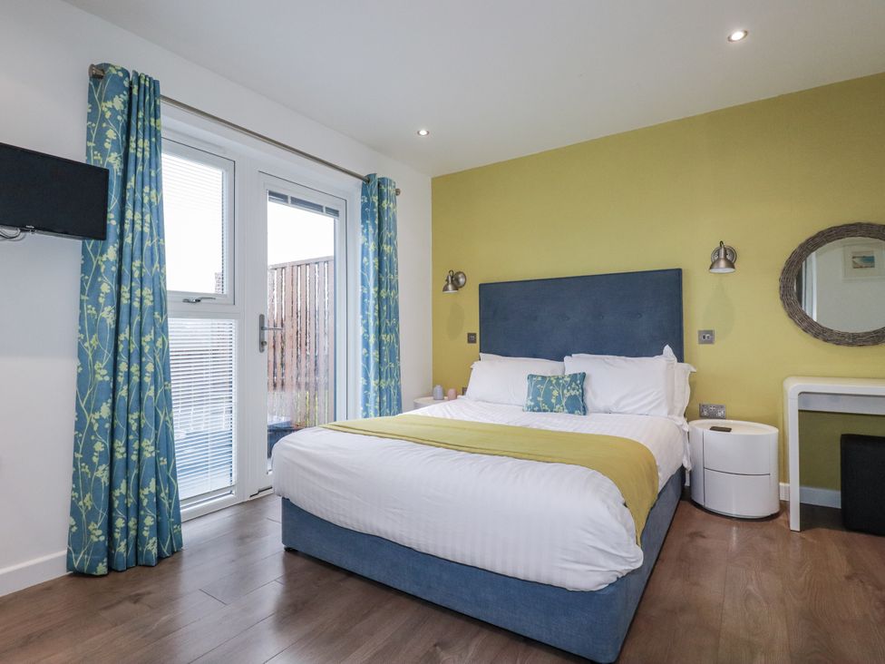 A bedroom with a bed and television at Pentewan in Redruth