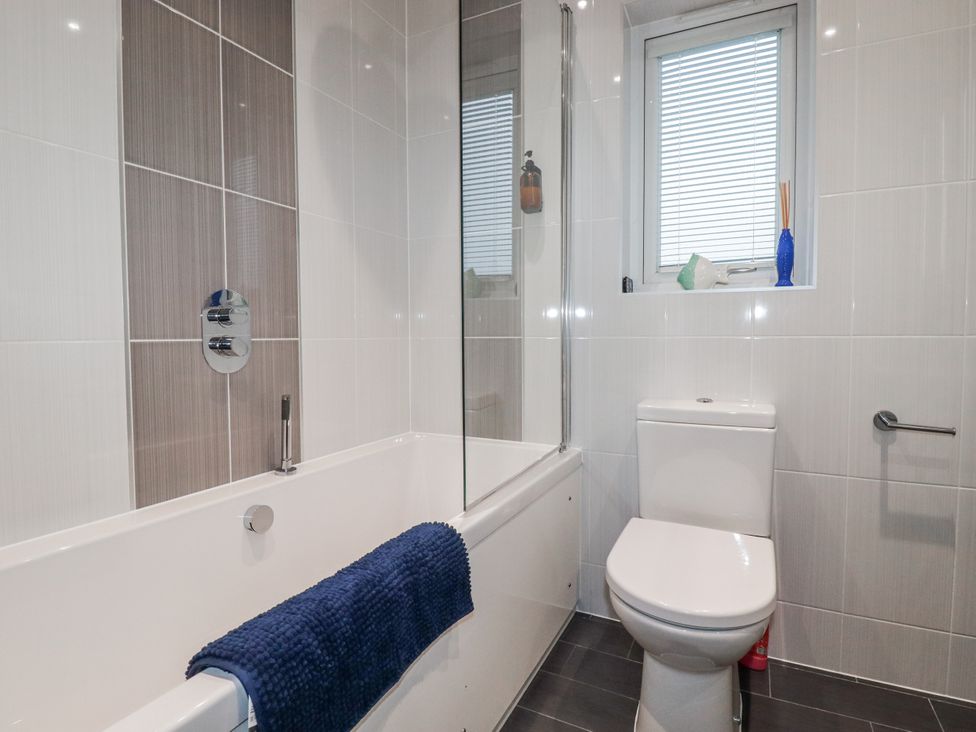 A bathroom featuring a bath tub and toilet at Pentewan in Redruth