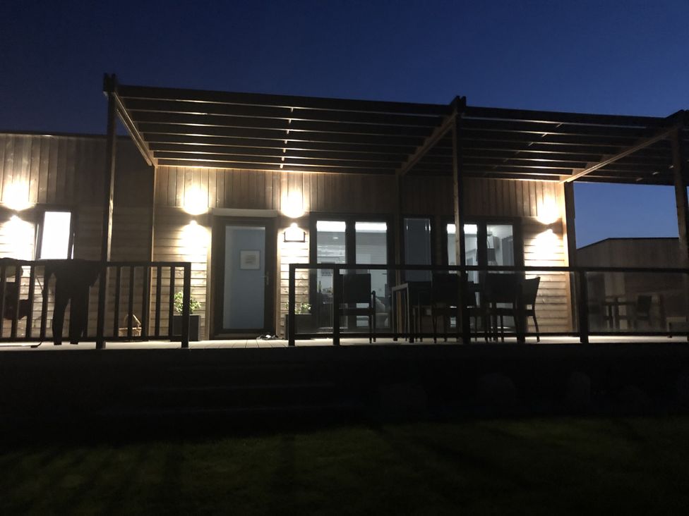 An outdoor area with a deck and furniture at Pentewan in Redruth