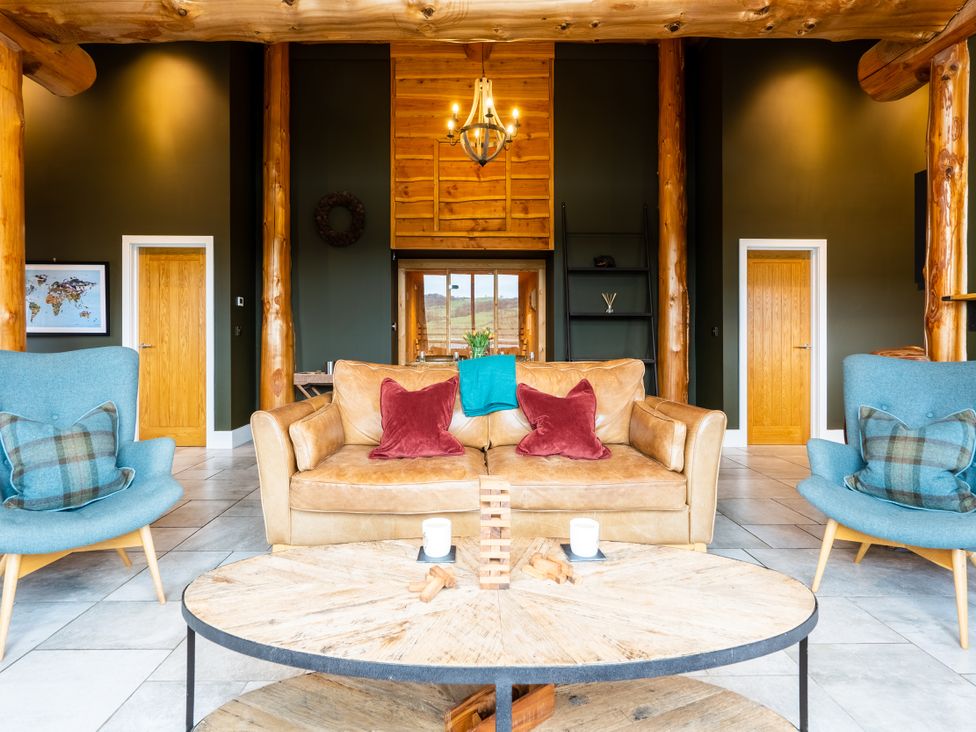 A living room with a sofa and chairs at Bears Den in Addingham