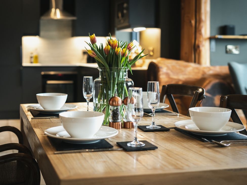A dining room with a table set for a meal at Bears Den in Addingham