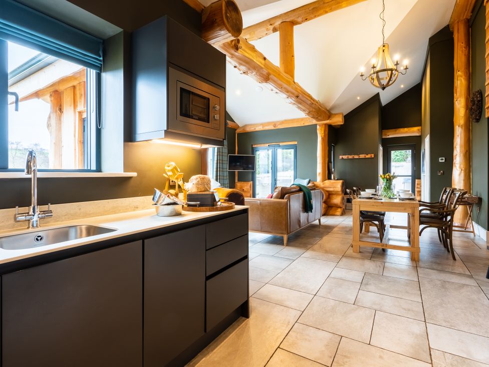 A kitchen with sink and microwave at Bears Den in Addingham