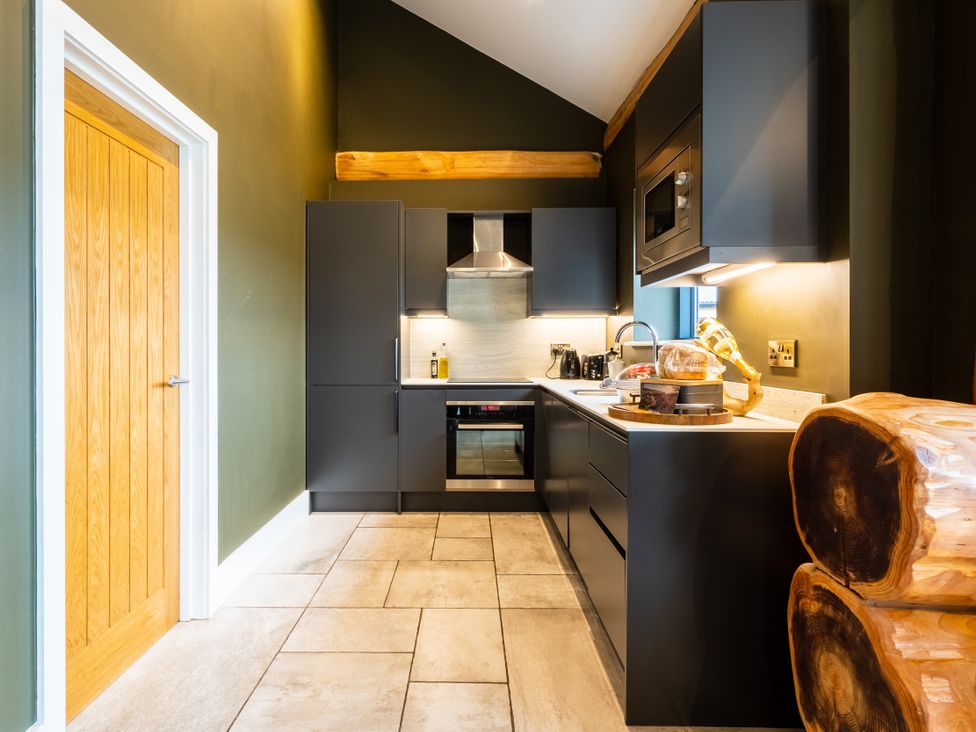 A kitchen with modern appliances at Bears Den in Addingham