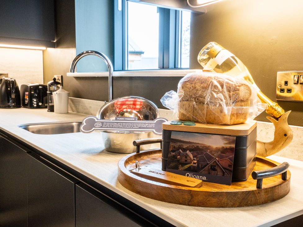 A kitchen with a loaf of bread and champagne on a serving tray at Bears Den in Addingham