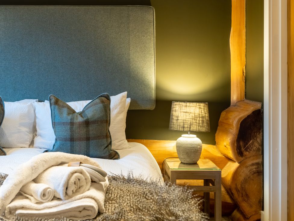 A bedroom with a bed and pillows at Bears Den in Addingham