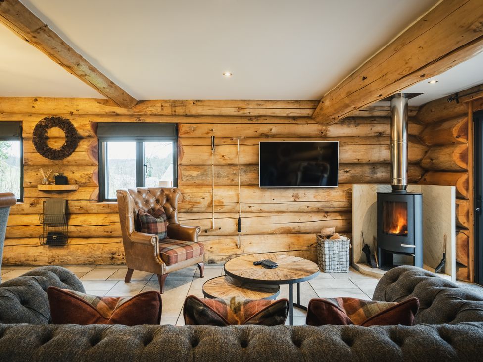 A living room with a sofa and armchair in Keepers Cabin Addingham