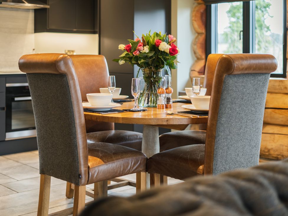 A dining room with a table set for meals at Keepers Cabin in Addingham