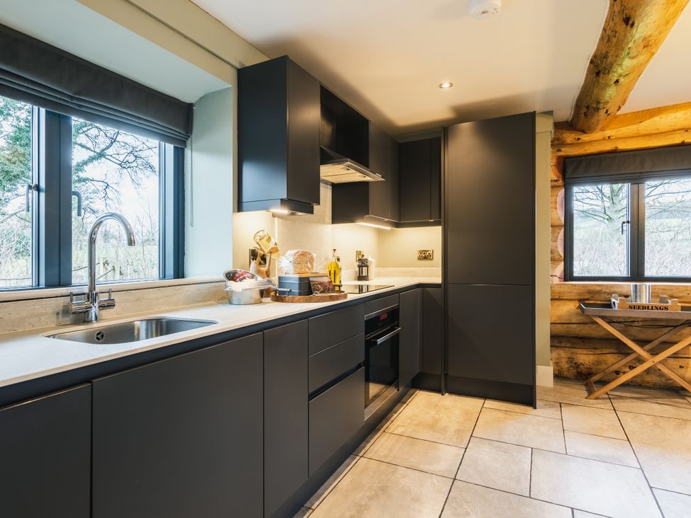A kitchen with cabinets and a sink at Keepers Cabin in Addingham