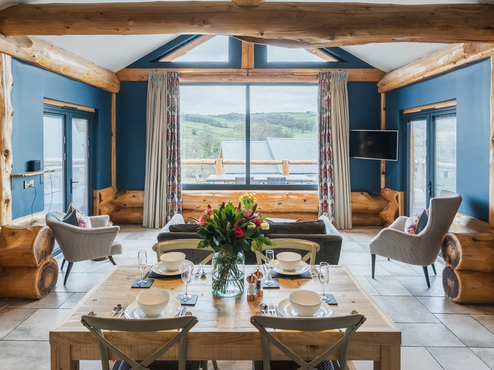 A dining room with a wooden table and chairs at The Farmhouse in Addingham
